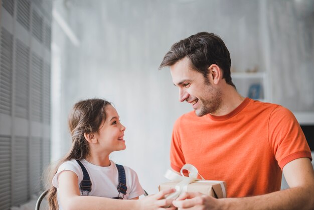 Fathers day concept with daughter giving present box