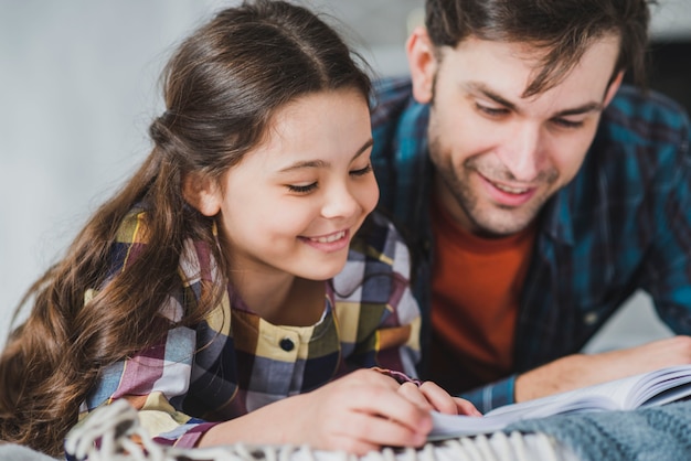 Fathers day concept with father and daughter reading