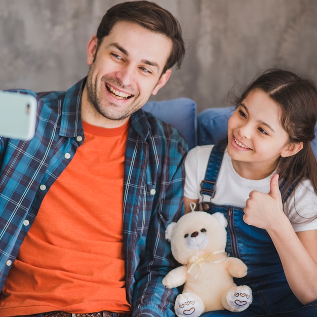 Fathers day concept with father and daughter taking selfie