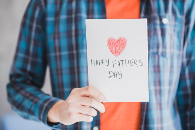 fathers day concept with father holding hand drawn card