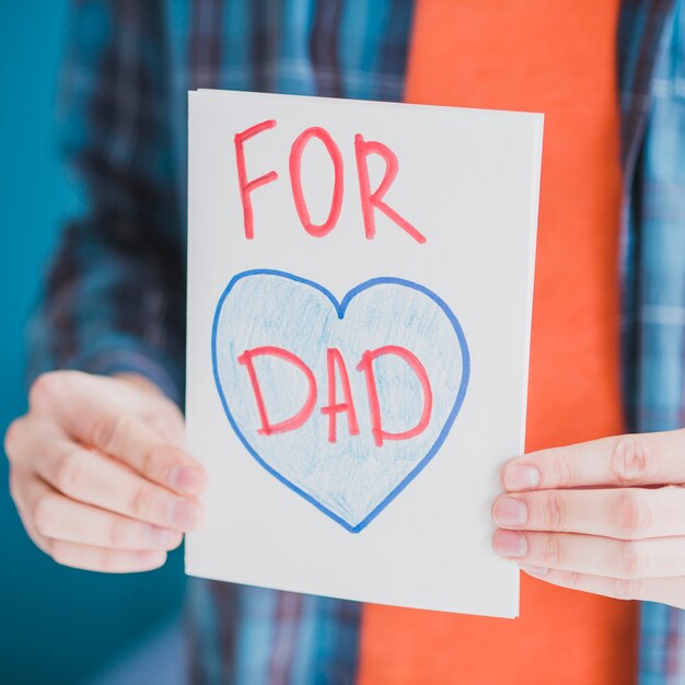 Fathers day concept with father holding hand drawn card