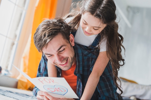 Fathers day concept with father reading in hand drawn card