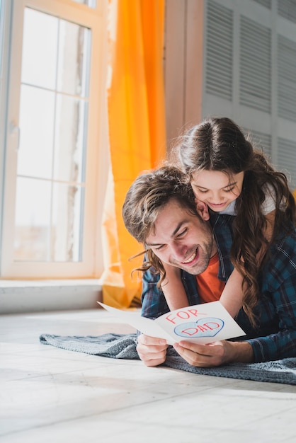 Fathers day concept with father reading in hand drawn card