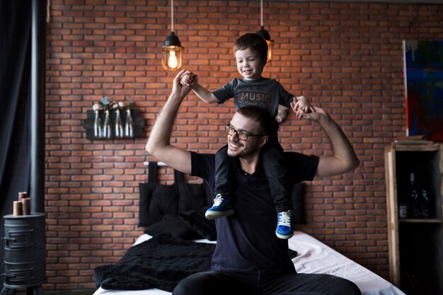 Fathers day concept with father and son on bed