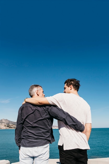 Fathers day concept with father and son in front of sea