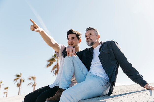 Fathers day concept with father and son sitting together