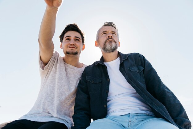 Fathers day concept with father and son sitting together