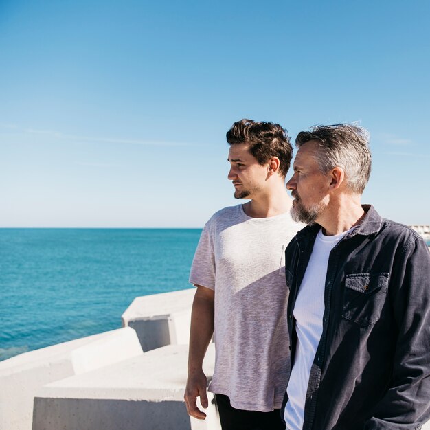 Fathers day concept with father and son walking next to sea