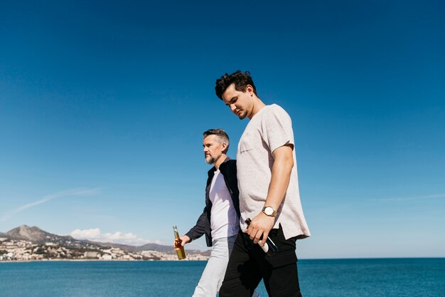 Fathers day concept with father and son walking with beer