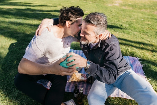 Free photo fathers day concept with son giving present to father and hug