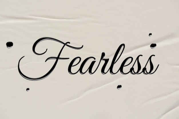 Free photo fearless word in ink calligraphy style