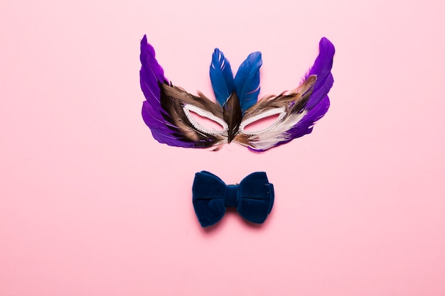 Free photo feather mask and bow tie