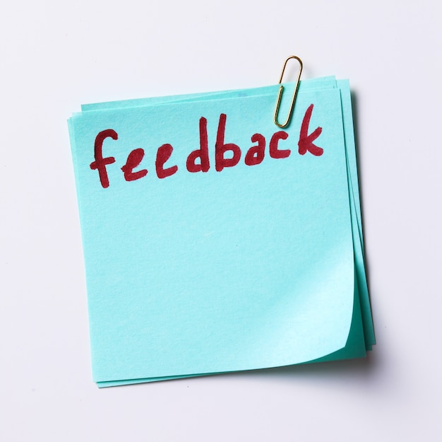 Feedback word written in a paper note