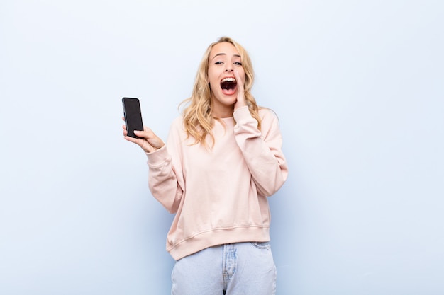 Free Photo | Happy excited woman holding mobile phone and celebrating win