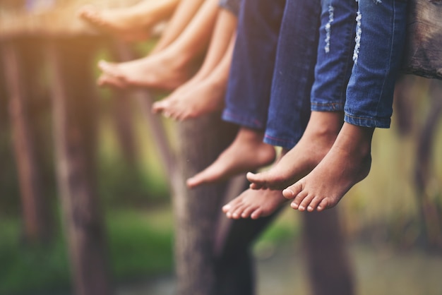 Feet of children sitting relaxed on the park