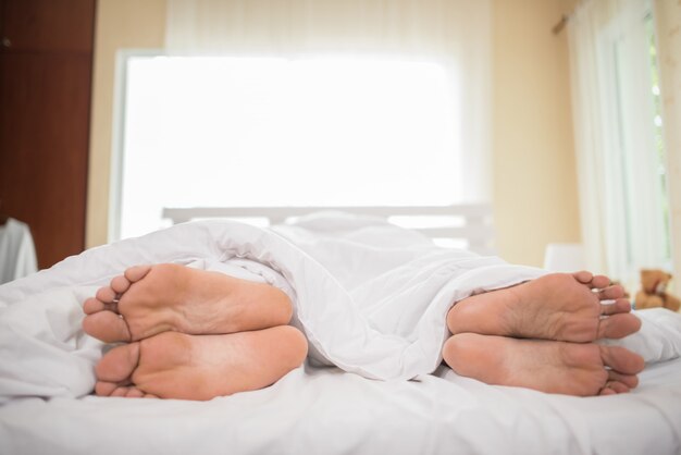 Feet of couple facing away from each other.