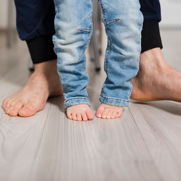 Feet of father and daughter