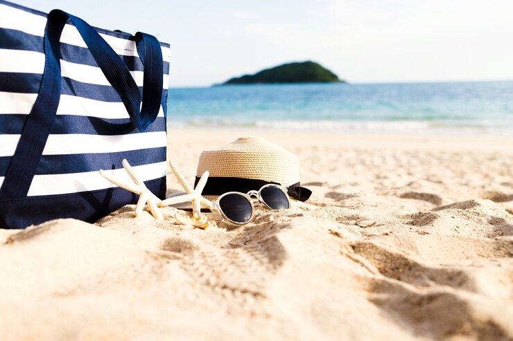 Free Photo female accessories and bag on beach