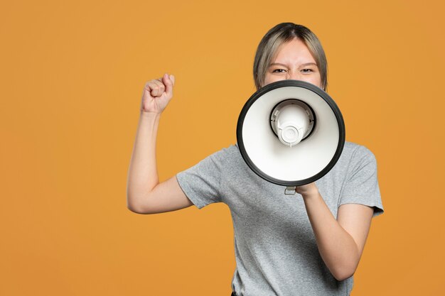 Female activist with a megaphone with design space