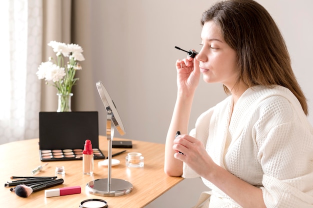 Female applying mascara