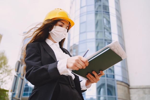 Female architect with construction site on the 