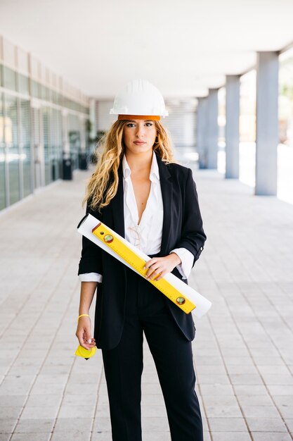 Female architect with helmet and plan