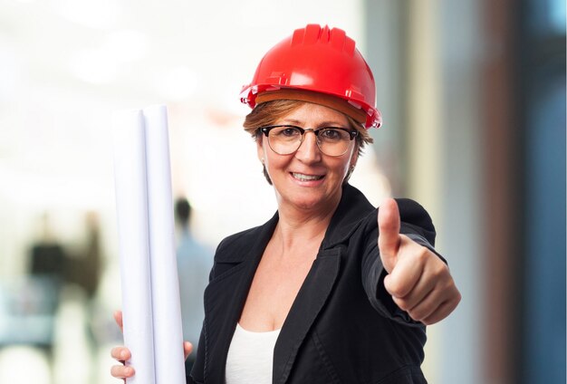 Female architect with thumb up