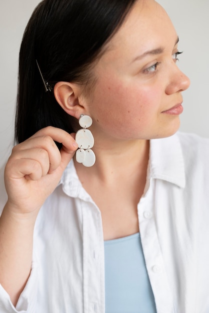 Free photo female artisan showing handmade earing