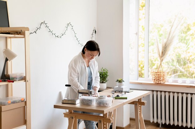 Female artisan working in the atelier with clay