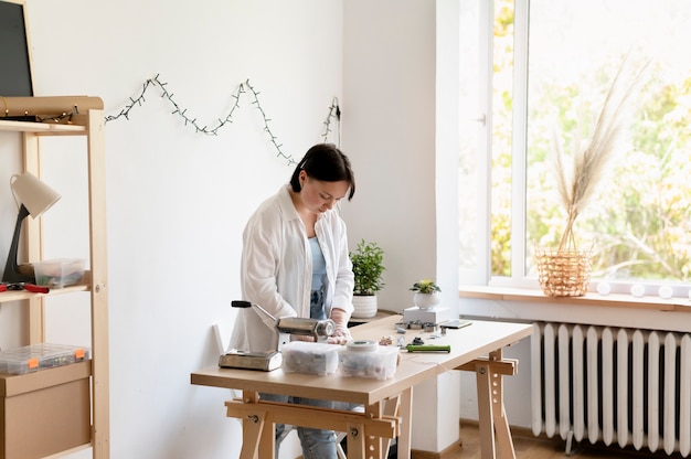 Female artisan working in the atelier with clay