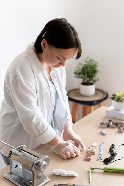 Female artisan working in the atelier with clay