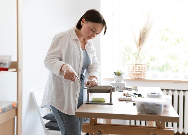 Female artisan working in the atelier with clay