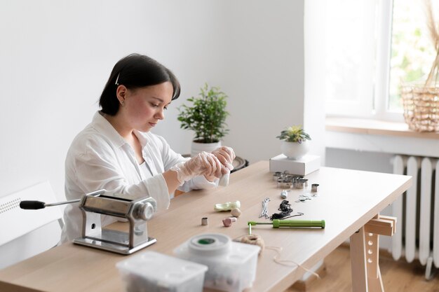 Female artisan working in the atelier with clay