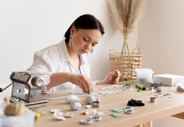 Female artisan working with clay in the atelier