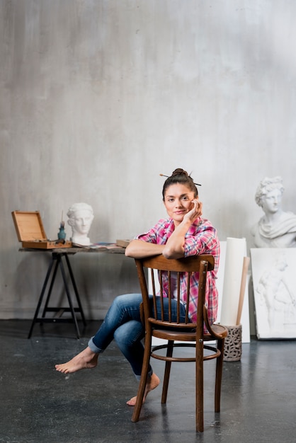 Female artist on chair