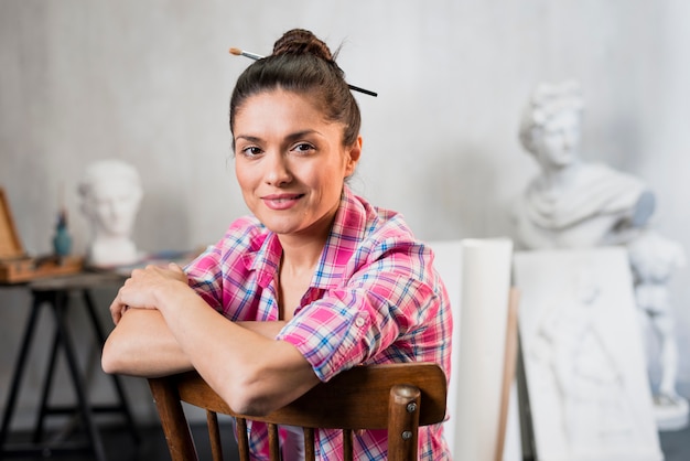 Free photo female artist on chair