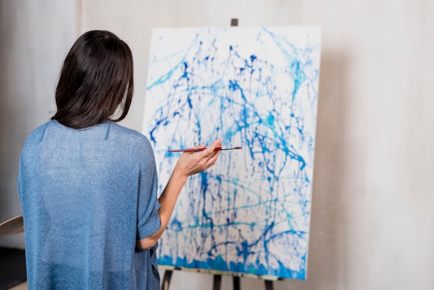 Female artist in front of canvas