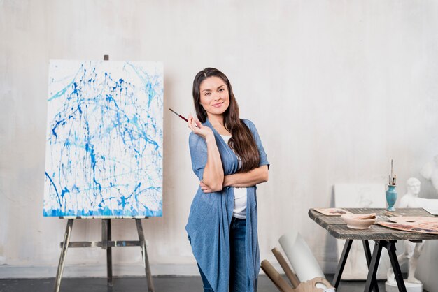 Female artist in front of canvas