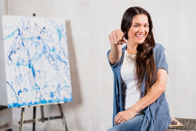 Female artist in front of canvas