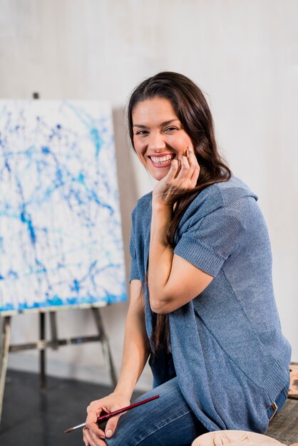 Female artist in front of canvas