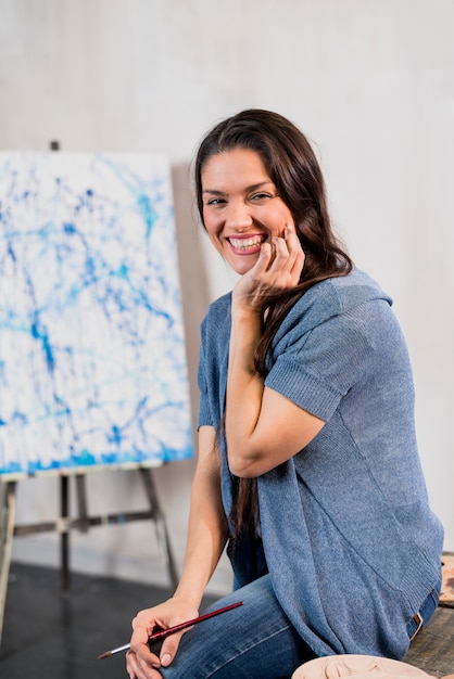 Female artist in front of canvas