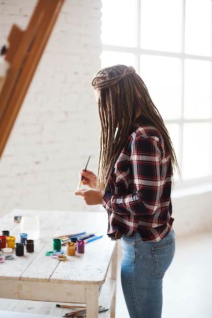 Female artist painting indoors