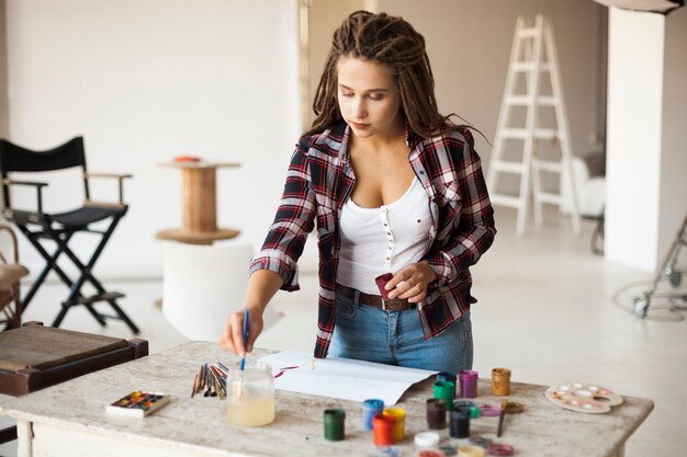 Female artist painting indoors