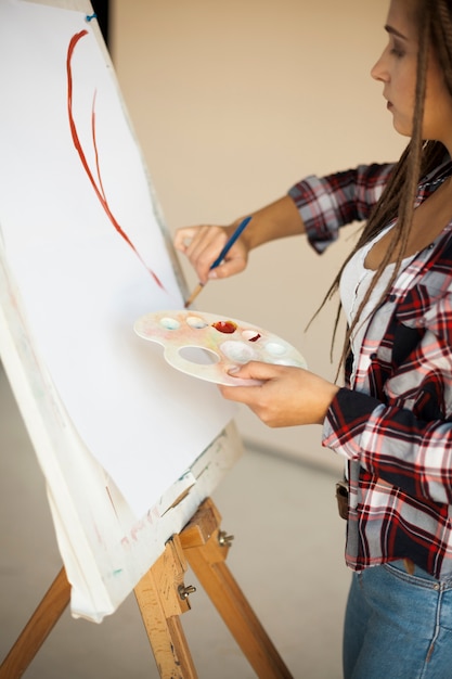 Female artist painting indoors