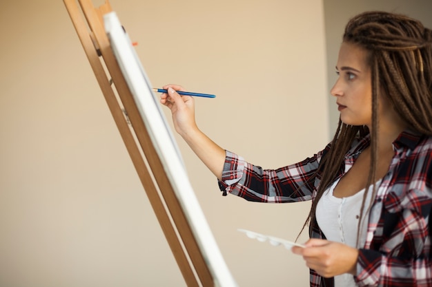 Female artist painting indoors