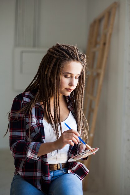 Female artist painting indoors