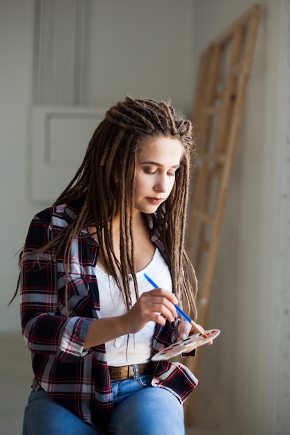 Female artist painting indoors