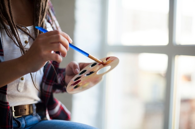 Female artist painting indoors