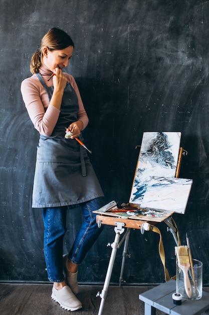 Female artist painting in studio