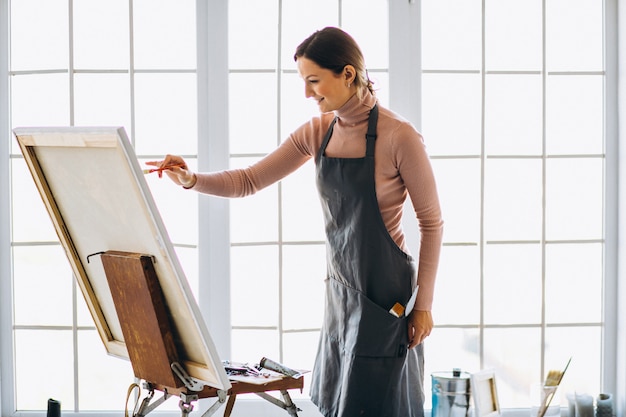 Female artist painting in studio